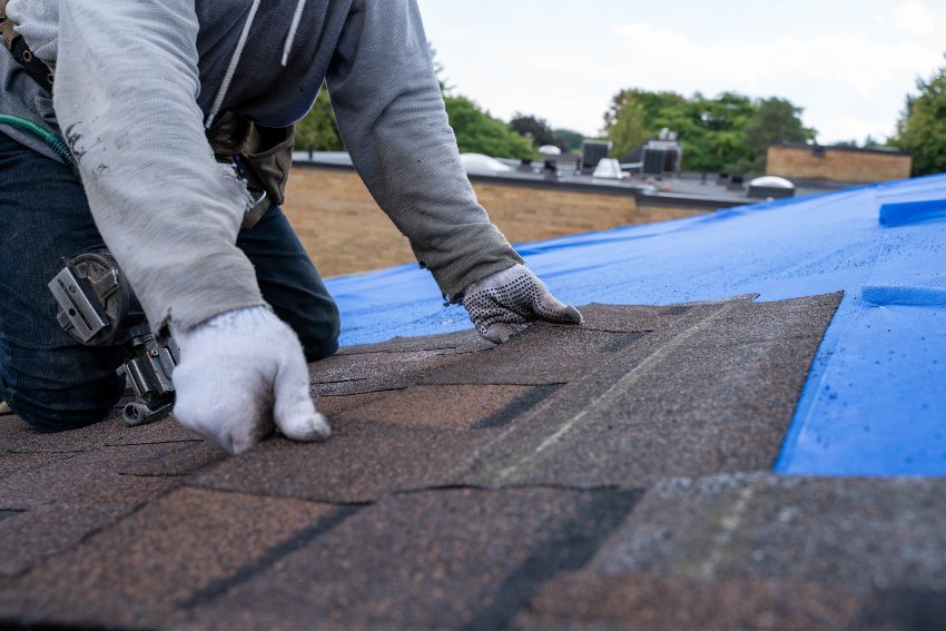 A Man Installs a Roof on a House in The Greater Toronto Area